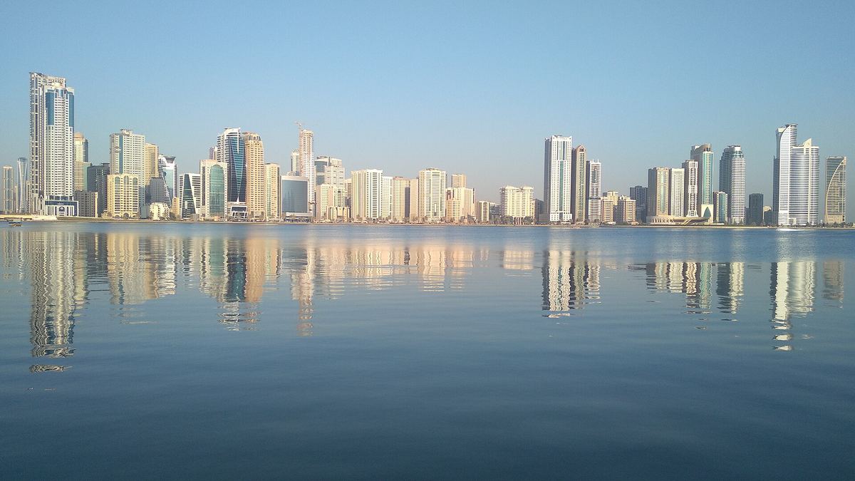 Area photo: the Al Majaz skyline across Khalid Lagoon from Buhairah Corniche
