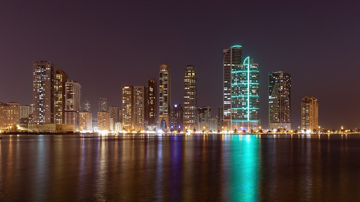 Area photo: Al Majaz towers at night across Khalid Lagoon